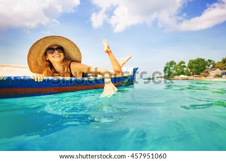 woman paddling in a boat in a paradise island