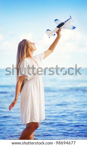 young woman with toy airplane