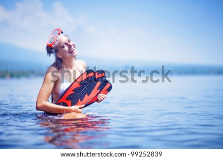 Beautiful woman portrait on the beach wearing snorkeling equipment, water sport, healthy lifestyle concept