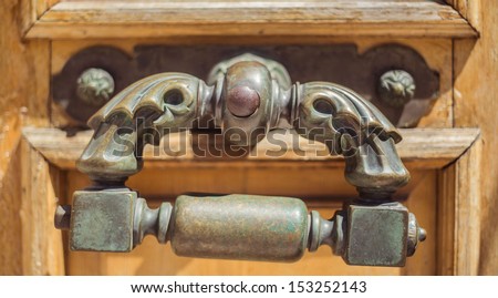 the bronze handle on an old wooden door (a museum of the Black Sea fleet)