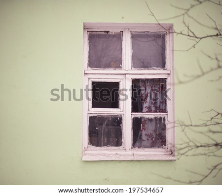old window with a color curtain on a light background