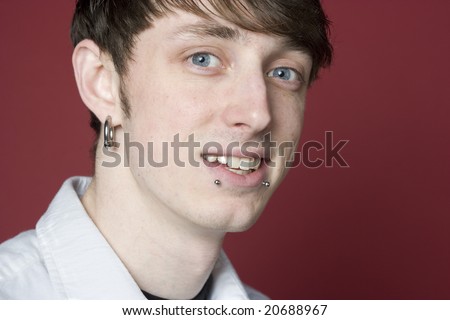 stock photo : Portrait of a young man with pierced ears and lips
