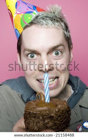 Man pondering birthday cupcake