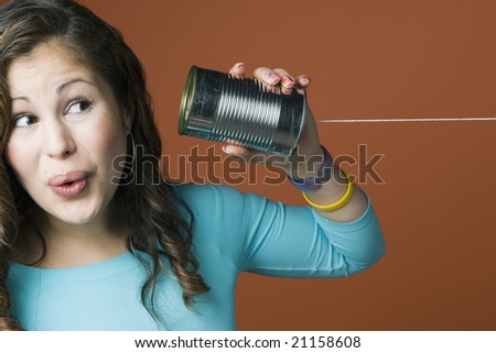 stock-photo-woman-receiving-a-message-on-a-tin-can-with-string-21158608.jpg