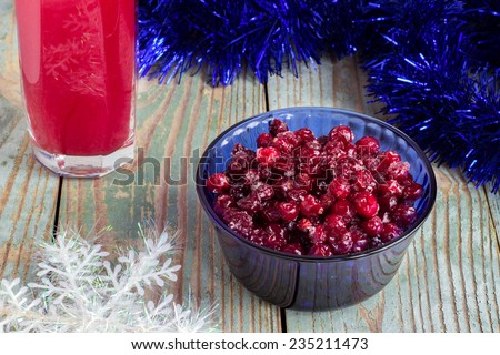 cranberries in a glass of sugar fruit drink background wooden