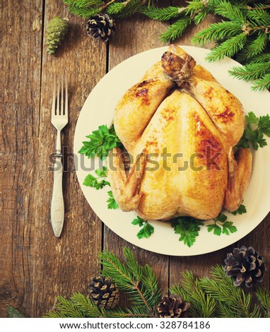 whole roast chicken on New Year\'s wooden table toning