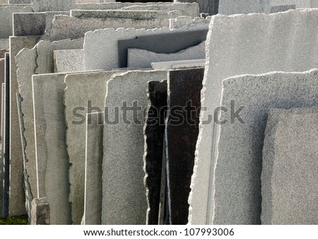 Row of natural stone panels in a mason\'s yard