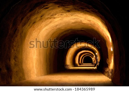 Vintage or under construction tunnel with dynamic visual effect made by the light of lanterns