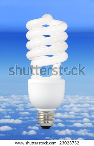 Low-energy light bulb over a blue sky background above the clouds