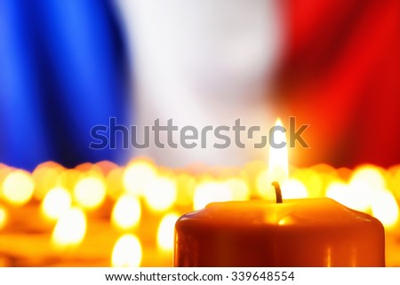 Lots of candles in front of the national colors of France in remembrance of the many victims of terror or to simply symbolize the great French spirit
