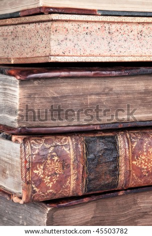 Detail of a pile of old leather bound books