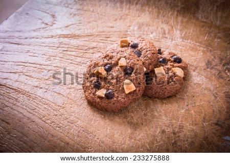 Chocolate chip cookies on wooden table. Stacked chocolate chip cookies close up