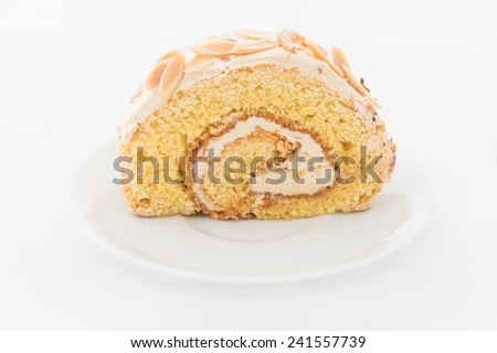 Almond roll cake on white dish. white background