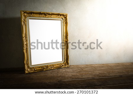 still life of luxurious photo frame on wooden table over grunge background. vintage tone