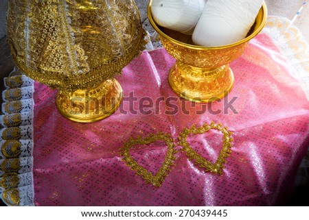 still life of Group of Thailand Gold tray with pedestal with The cover is made of lace on pink cloth. Thailand Culture Wedding Ceremony