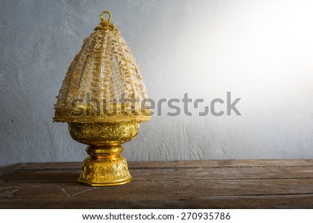 still life of Thailand Gold tray with pedestal with The cover is made of lace on wooden table with grunge background. Thailand Culture Wedding Ceremony