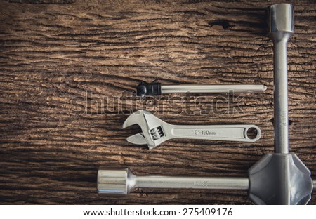 group of emergency rescue equipment in the car on wooden background, maintenance concept