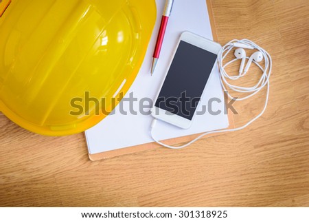 safety helmet, clipboard, notebook, pen on wooden table. top view. Construction concepts