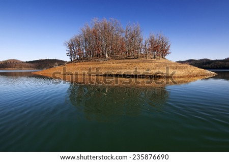 Small island inside calm lake.