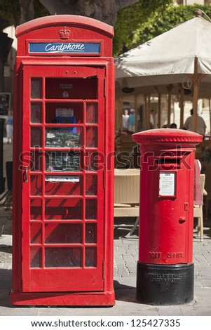 Old British phone box and letter pillar in the city of Valletta in Malta.
