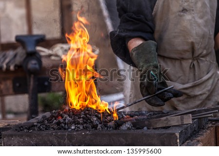 Detail shot of metal being worked at a blacksmith forge