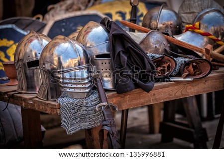 Table with various pieces of medieval armour