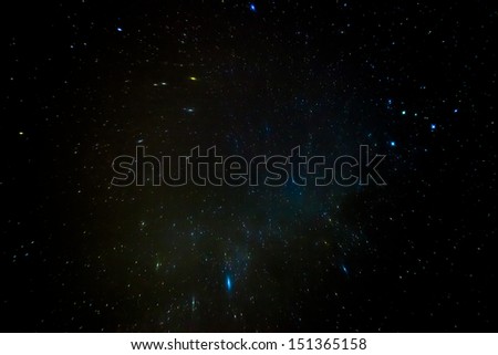 A wide field astrophotographic image showing real stars and cluster nebula
