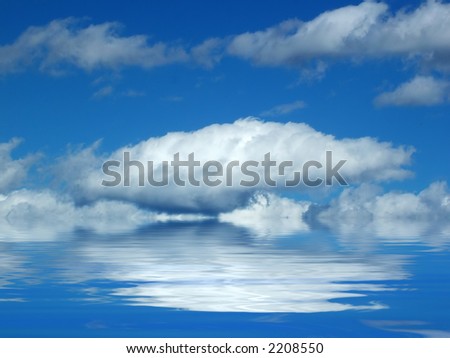 Cloud reflected in calm ocean waters, against summery blue sky