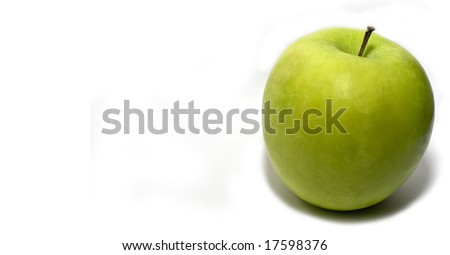 A ripe granny Smith apple over a plain white background