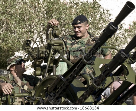 MALTA- OCTOBER 06 - Soldiers demonstrating an Anti-Aircraft Gun during an Armed Forces of Malta open day at Luqa Barracks