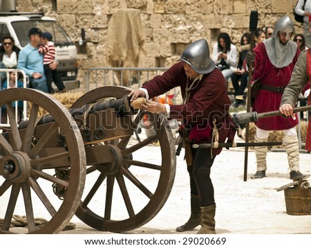 MDINA, MALTA - APR19 -  Knights firing a cannon during medieval reenactment in the old city of Mdina in Malta April 19, 2009