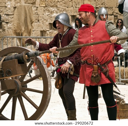 MDINA, MALTA - APR19 -  Knights firing a cannon during medieval reenactment in the old city of Mdina in Malta April 19, 2009