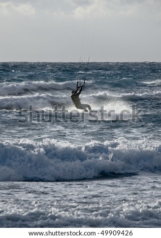 Man enjoying kite surfing at Golden Bay in Malta
