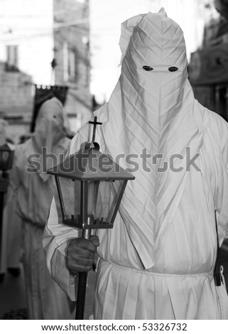 MOSTA, MALTA - APR 02: Hooded men in white habits during the Mosta Good Friday procession in Malta April 02, 2010
