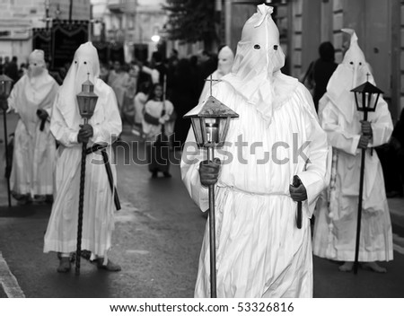 MOSTA, MALTA - APR 02: Hooded men in white habits during the Mosta Good Friday procession in Malta April 02, 2010