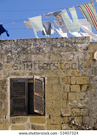 Clean linen and laundry hanging on a clothes line on a rooftop in Malta.