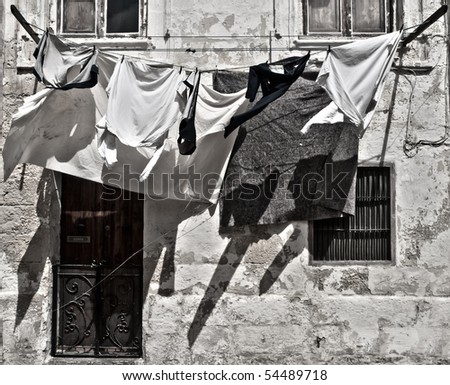 Clean linen and laundry hanging on a clothes line in a street in Valletta