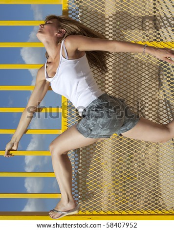 A conceptual image showing a woman against a yellow metal barrier and a rotated backdrop