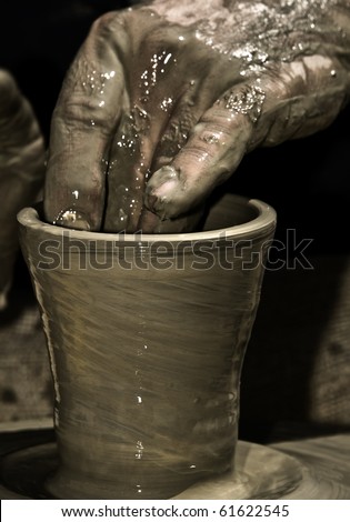 Detail of a potter\'s hand while creating a new work of art