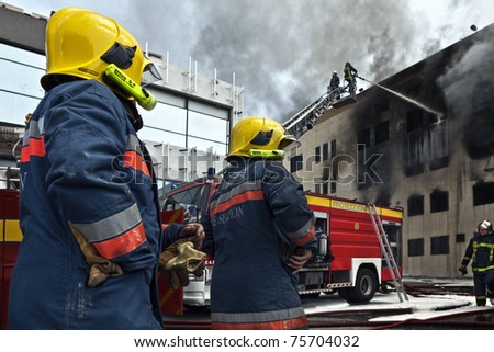 MRIEHEL, MALTA - APR 12 - Enemalta Fore Section personnel lend a hand to the Civil Protection firefighters during a fierce fire which engulfed detergents factory on April 12, 2011 in Mriehel, Malta