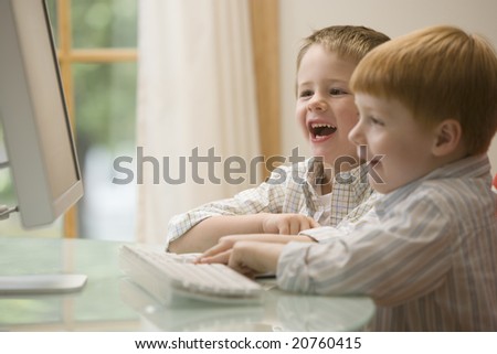 Young boys having fun at the computer