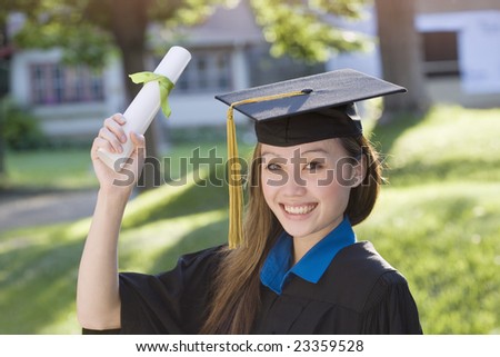 Pretty Asian woman graduate wearing cap and gown holding diploma