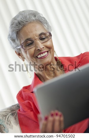 Stylish senior Black woman using a digital tablet