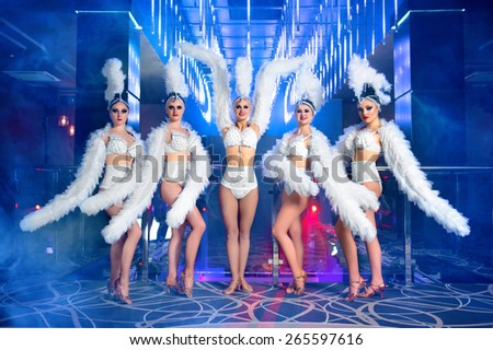 dance group of sexy young woman in costume, at the disco