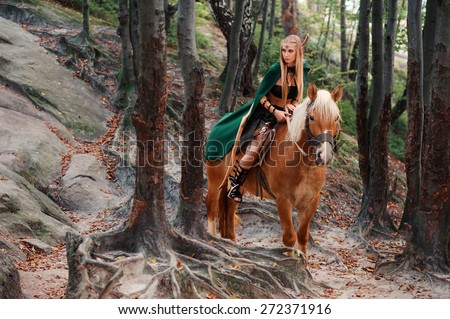sexy woman elf warrior on horseback in the woods