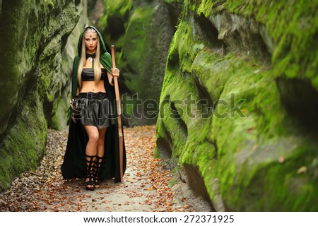 Woman elf warrior with a bow is a fabulous mountains