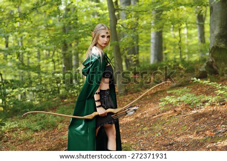 female elf with a bow in the forest