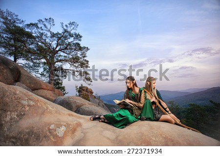 female elves in fairy mountains against the sky