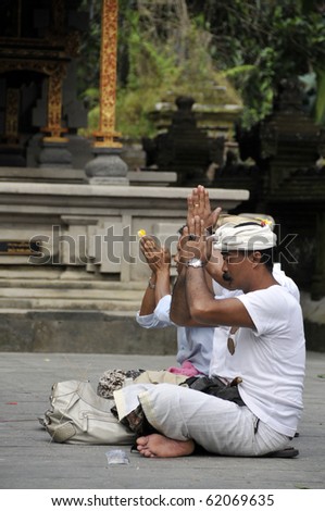 BALI, INDONESIA - JUNE 22: A group of Hindu believers came to the 2nd biggest Hindu temple in Bali Island to pray and to give offering to God, June 22, 2010 in Bali, Indonesia.