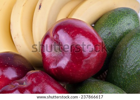 Close-up of delicious and healthy apples, bananas and avocados.